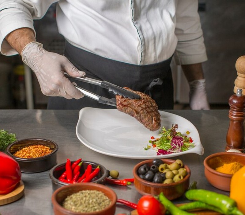 chef putting grilled steak serving plate with herbs salad 141793 164